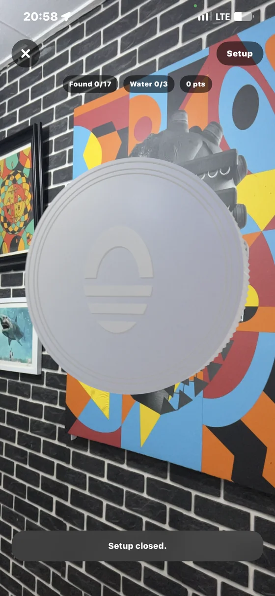 An augmented reality coin floating over a mural